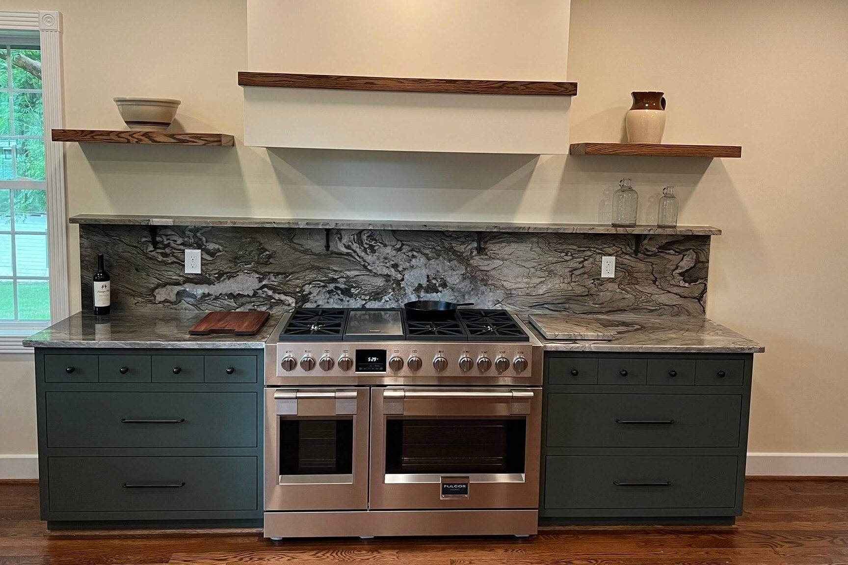 Remodeled country kitchen with new cabinets, freestanding shelves, and granite backsplash.